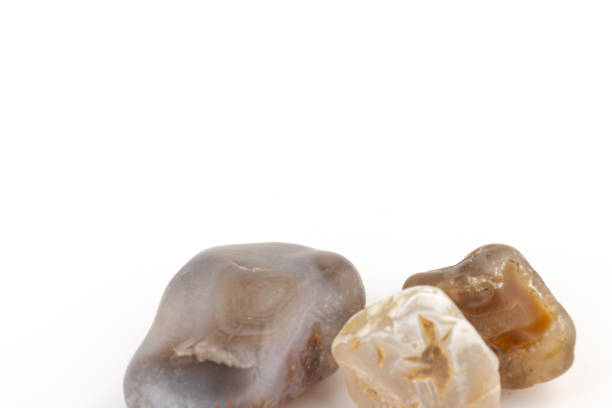 istock Multicolored gemstones, tumbled minerals. Bostwan agate of various sizes on a white background. 1444789246