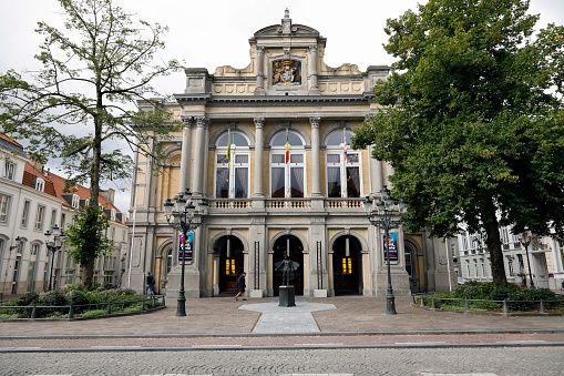 Bruges, Belgium - September 15, 2022: The facade of the theater is viewed slightly at an angle here, revealing ornate architectural details of this magnificent building