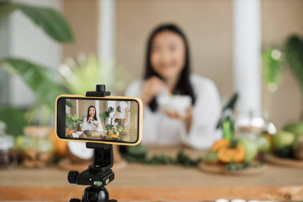 istock Young asian woman blogger or content creator in white bathrobe preparing cream. 1444792184