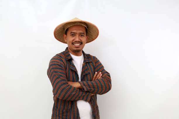 istock Happy asian farmer standing with folded arm. Isolated on white background 1444792978