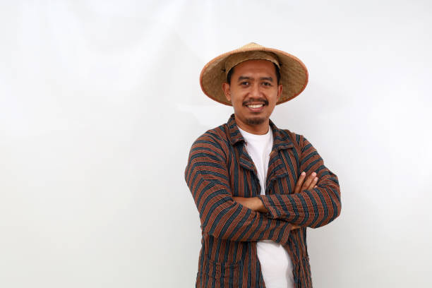 Happy asian farmer standing with folded arm. Isolated on white background