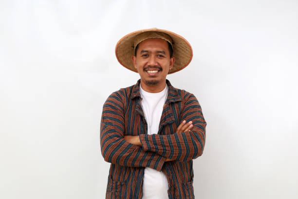 istock Happy asian farmer standing with folded arm. Isolated on white background 1444793522