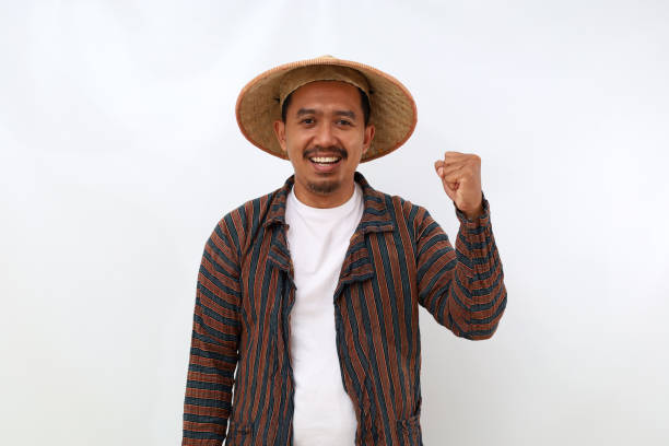 istock Happy asian farmer standing with clenched hand. Isolated on white background 1444793717