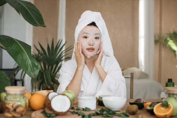 istock Attractive young asian lady applying cotton face mask 1444794459
