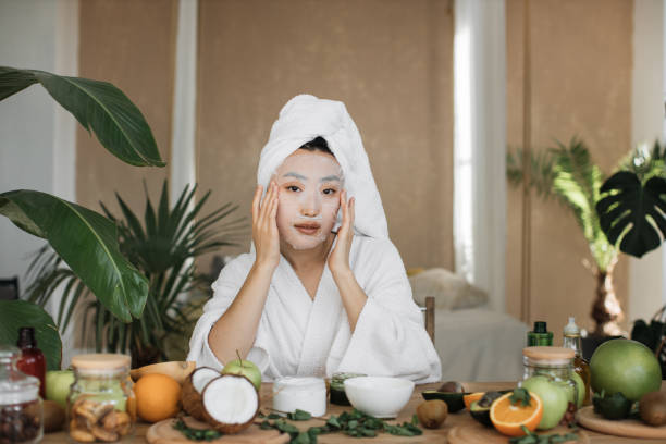 istock Attractive young asian lady applying cotton face mask 1444794463