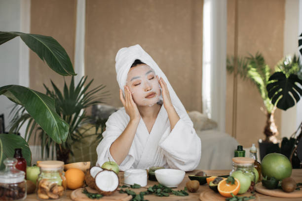 istock Attractive young asian lady applying cotton face mask 1444794465