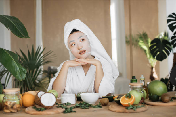 istock Attractive young asian lady applying cotton face mask 1444794513