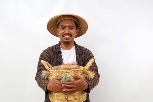 istock Happy asian farmer standing while holding an empty basket. Isolated on white background 1444795678