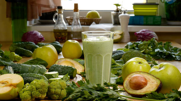 istock Organic Freshly Squeezed Green Vegetable and Fruit smoothie Into the Glass 1444795957