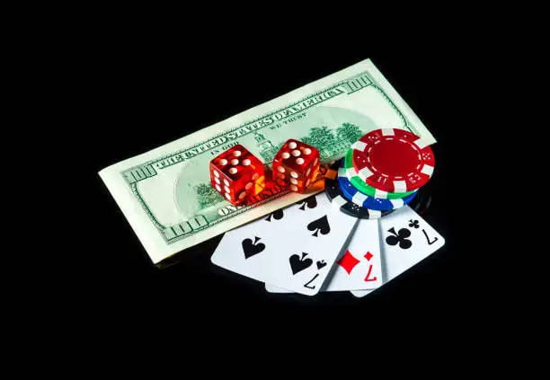 Three of a kind or set cards combination and dollars with chips. Winning combination at a poker club or casino