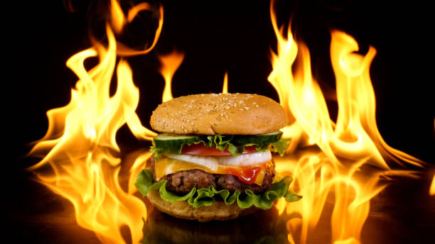 istock Delicious burger on the background of fire 1444796241