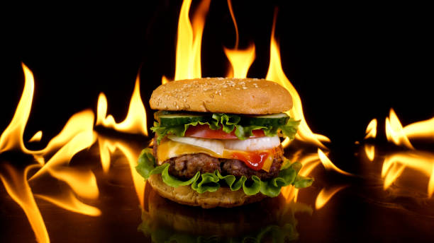 istock Delicious burger on the background of fire 1444796294