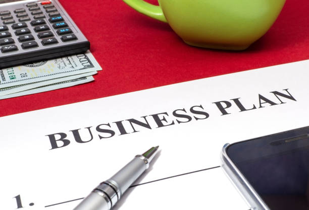 istock Strategy business plan with pen, coffee, calculator and money on red table. 1444797572