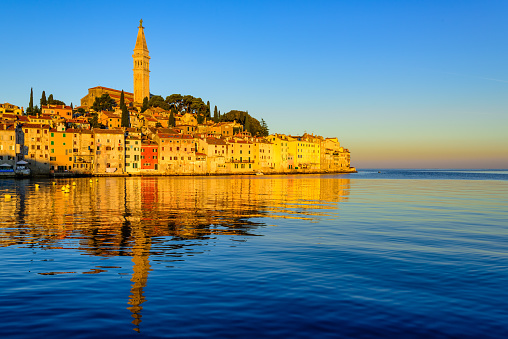 Rovinj historical city on Istria peninsula, Croatia, reflecting in Mediterranean sea on sunrise. Rovinj is a popular tourist resort on Adriatic coast.