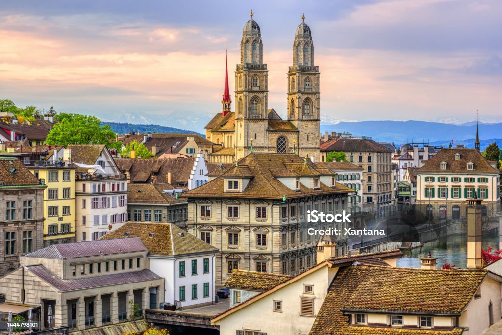 Zurich cathedral and Old town, Switzerland Zurich city center, view over Old town roofs to Grossmunster cathedral, Switzerland Zurich Stock Photo
