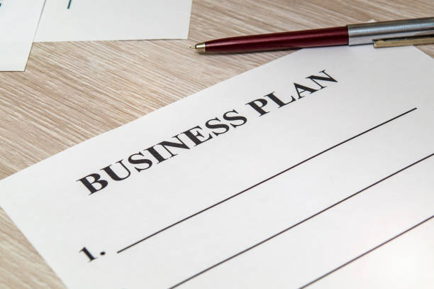 istock Blank form and pen for drawing up business plan on table in the office 1444798376