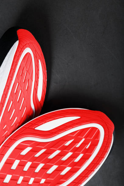 istock Running shoes with red soles on a black background 1444799672