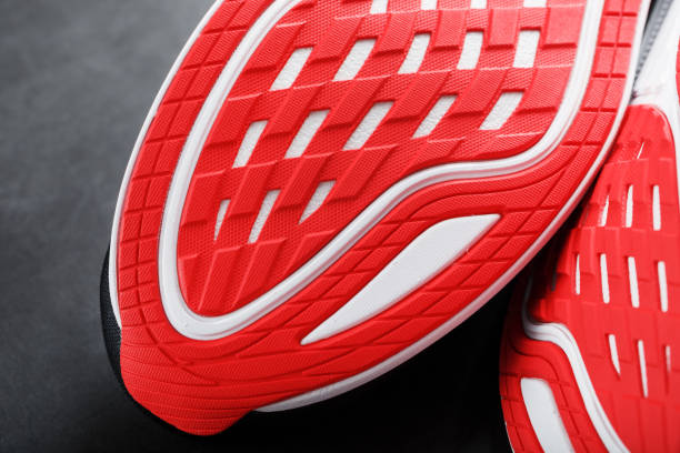 istock Running shoes with red soles on a black background. 1444799967
