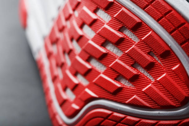 istock Running shoes with red soles on a black background. 1444799993