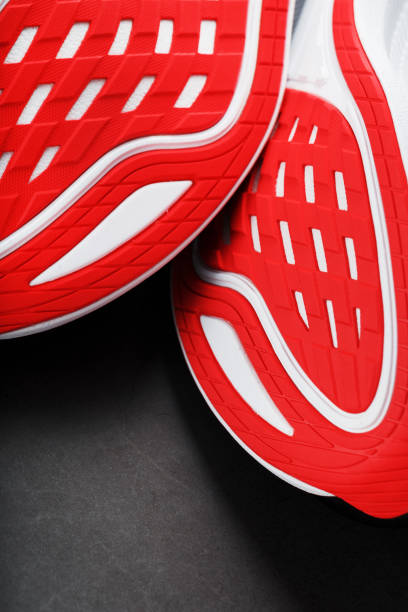 istock Running shoes with red soles on a black background. 1444800014