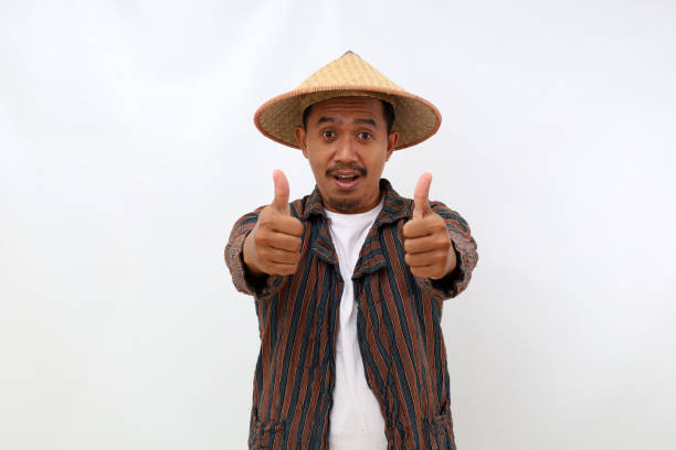 istock Happy asian farmer standing while showing thumbs up. Isolated on white background 1444800311