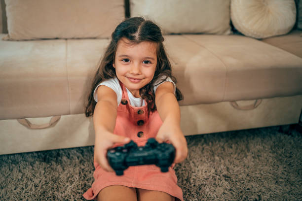 istock Cute girl playing video games 1444807688