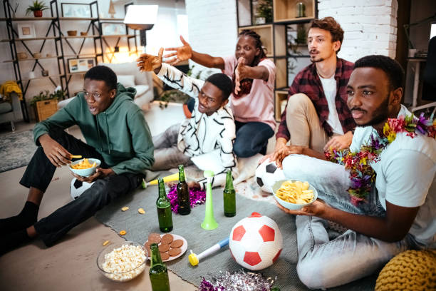 istock Friends cheer for their team together 1444810340
