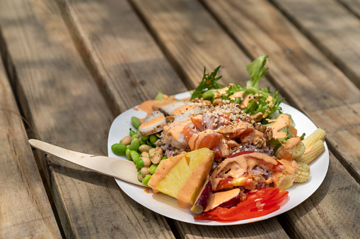 A Hawaiian poke plate served at a picnic party at a farm in Kenting, Taiwan. The plate is made of recycled paper, while the fork is made of bamboo stem.