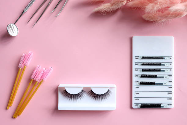 istock Tools for eyelash extension on trendy pastel pink background. False eyelashes, tweezers and brushes. Beauty shop. Makeup cosmetics. Top view, flat lay 1444820674