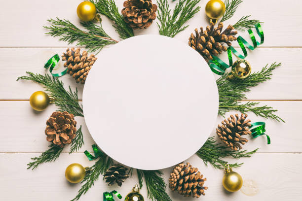 istock Flat lay Christmas composition. Round Paper blank, pine tree branches, christmas decorations on Colored background. Top view, copy space for text 1444823464