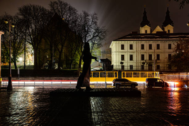 Lviv, Ukraine - November 23, 2022: Lviv during partial blackout after  Russian missile attack. Ivan Fedorov monument at night