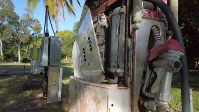 Disused vintage fuel pump rusting and decaying - a symbol of the end of fossil fuels and a transition to electric vehicles powered by renewable energy