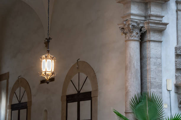 Palermo, Sicily, Italy - oct 7, 2022: a retro-style lamp illuminates the entrance arch of a noble nineteenth-century palace in Palermo.