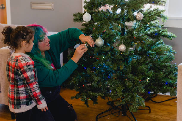 istock Multi Racial Family Decorating Christmas Tree At Home 1444830275
