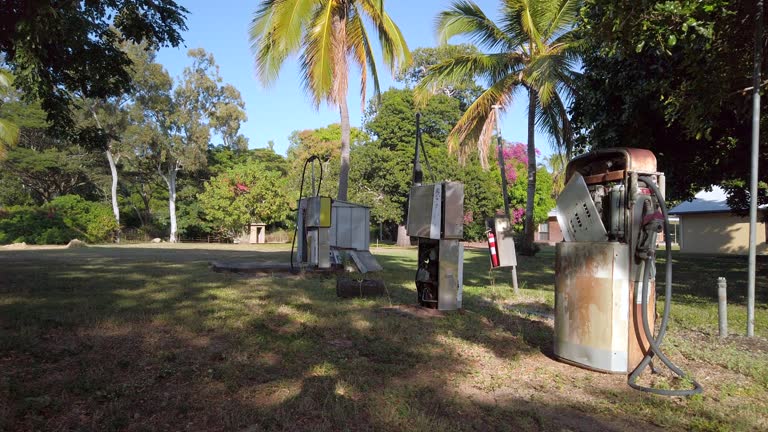 Disused vintage fuel pump rusting and decaying - a symbol of the end of fossil fuels and a transition to electric vehicles powered by renewable energy