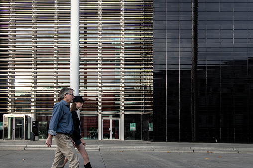 Copenhagen, Denmark Oct 29, 2022 A couple walk by the facade of the DR, Danish Radio, broadcasting building and concert hall.