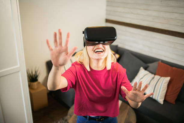 istock Woman using VR glasses at home 1444837867