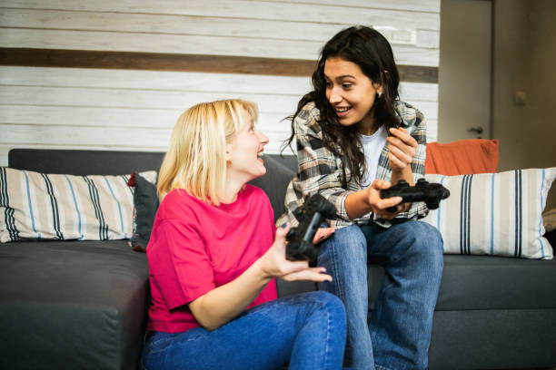 istock Sisters playing video game at home 1444839902