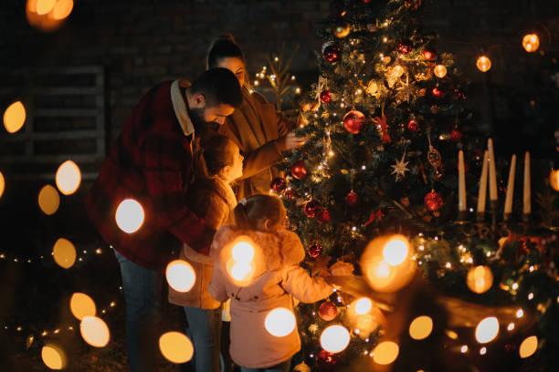 istock Happy family standing around the Christmas tree 1444840095