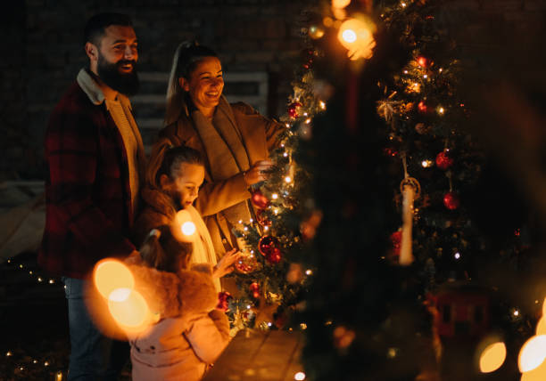 istock Family decorating the Christmas tree 1444840097