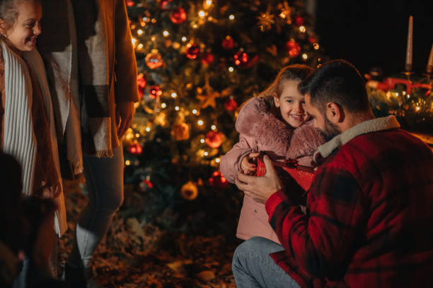 istock Young girl getting a Christmas present from her dad 1444840350