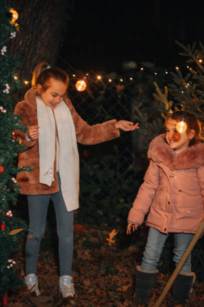 istock Young sisters having fun outdoors on Christmas eve 1444840946