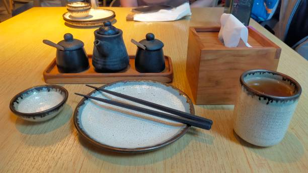 istock Tabel ware at sushi restaurant, tissue, wasabi, chili powder, pepper, tissue box, cup, plate and chopstick. 1444847406