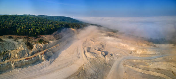 istock Aerial view of open pit mining of limestone materials for construction industry with excavators and dump trucks. 1444848276