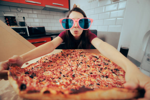Funny Woman Celebrating Alone Eating a Giant Pizza