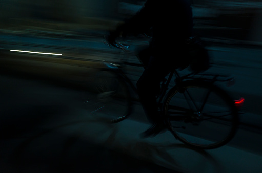 Cyclist riding at night in Toronto: Blurred motion
