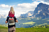 Father and his little daughter admiring a view of Seiser Alm, the largest high altitude Alpine meadow in Europe, Italy