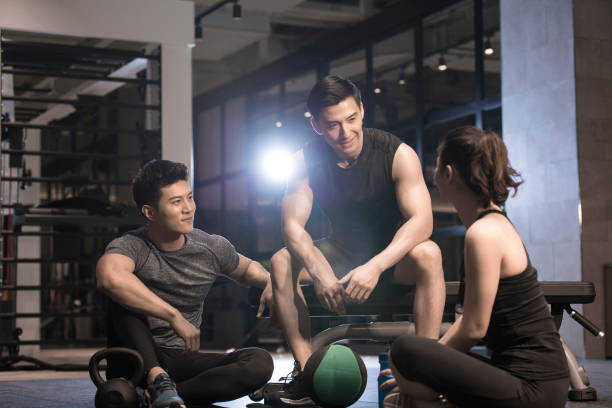 istock Three young people relaxing and chatting together in the gym 1444867306