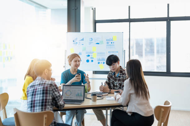 istock Young people working together in the office. Collaborating with colleagues, discussing, discussing, planning together in the office 1444867389
