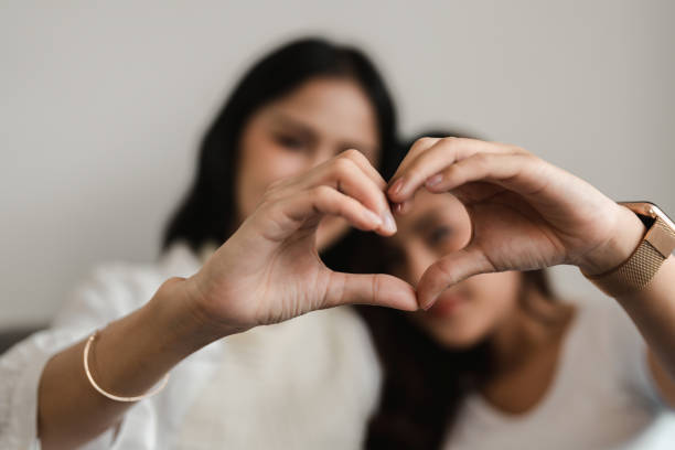 istock Lesbian lifestyle girlfriends doing heart shape symbol with hands 1444869167